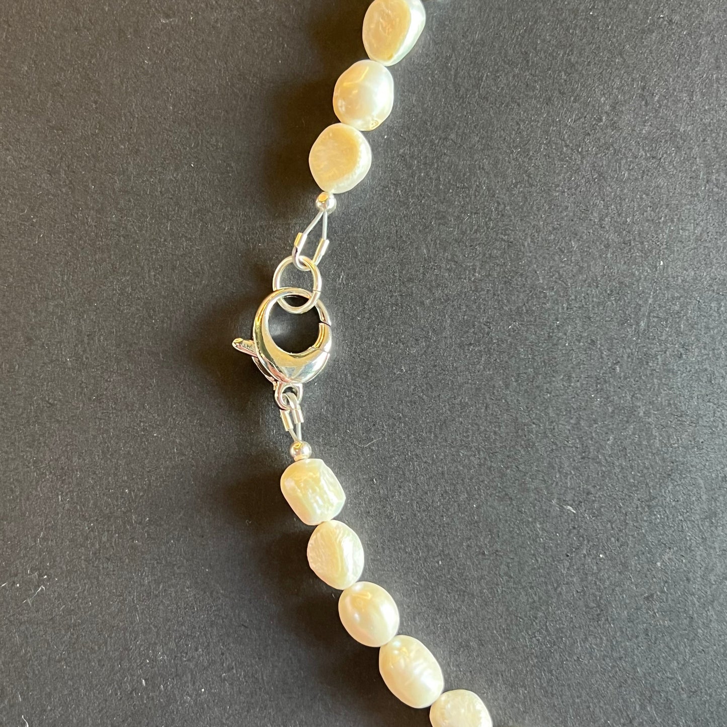 Pearl necklace on a dark gray background
