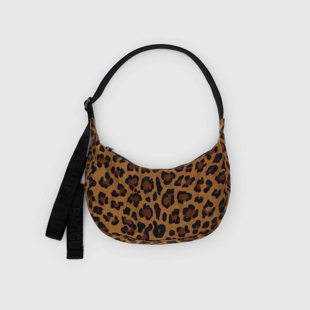 Leopard print handbag with a black strap on a light gray background